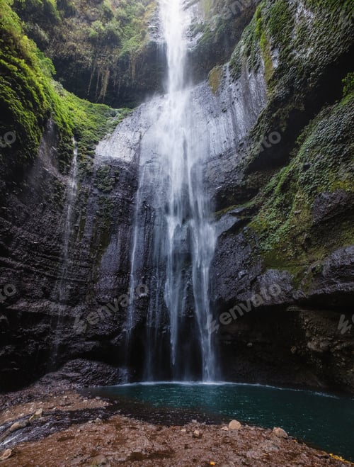 Preview: Majestic waterfall flowing on rock cliff in rainforest