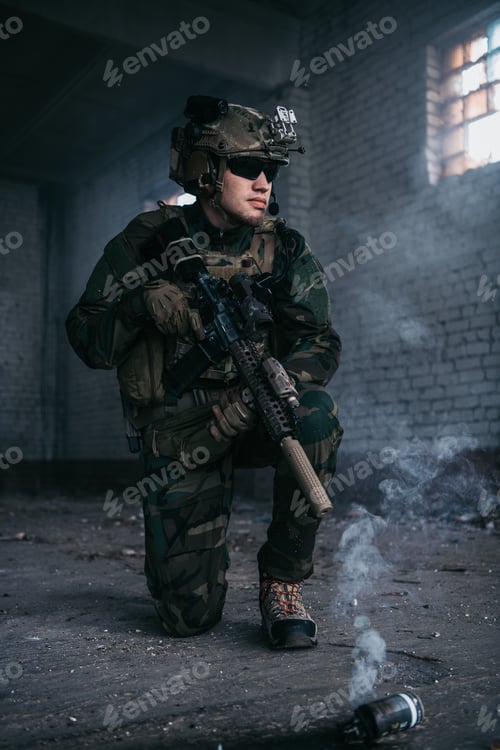 Preview: Military man during combat and smoke grenade on a ground