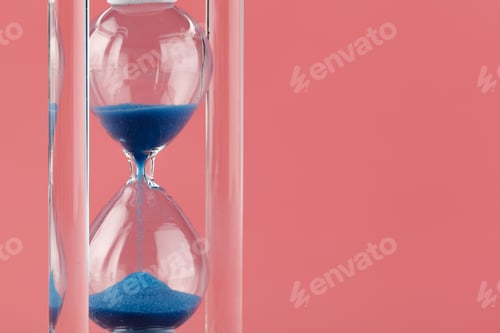 Preview: Close up of sandglass on paper background