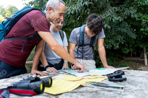 Preview: Family hiking finding route on trekking map