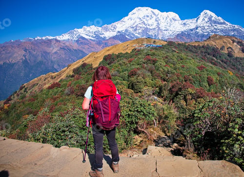 Preview: Senior woman standing on the ridge in Himalayas mountains