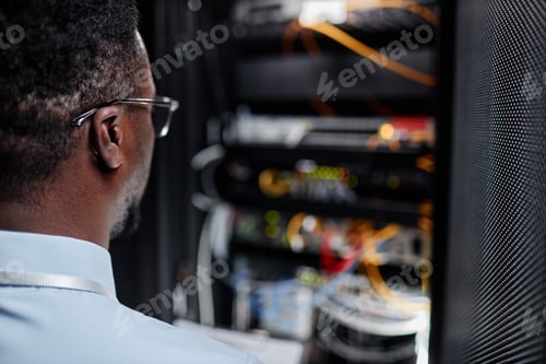 Preview: Back view black system engineer working with server cabinet in data center