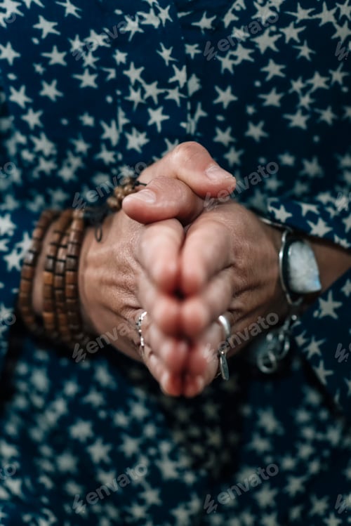 Preview: Woman Holds Hands Joined Together at Chest.