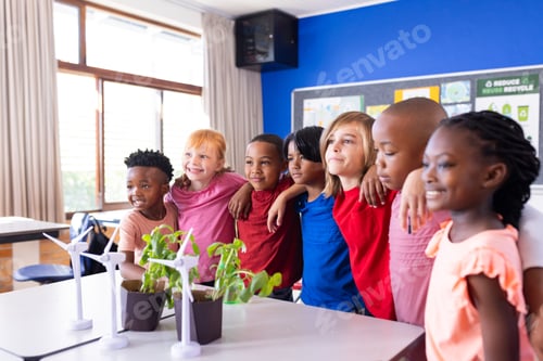 Preview: In school, diverse group of children standing together, smiling near wind turbines