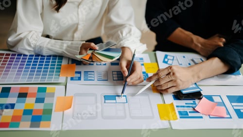 Preview: UX developer and ui designer brainstorming about mobile app interface wireframe design with customer