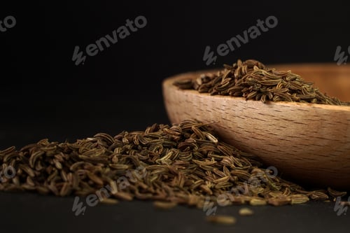 Preview: Wooden plate with caraway powder in a wooden bowl shape