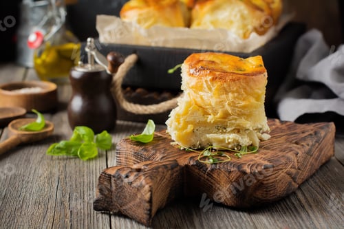 Preview: Buns with feta cheese and basil of yeast dough on a dark wooden background. Selective focus. Rustic