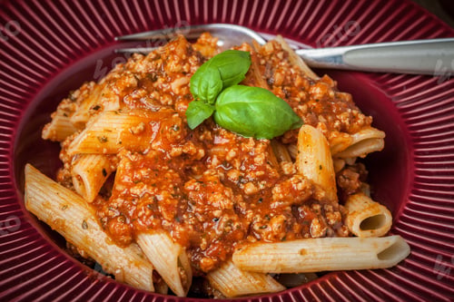 Preview: Penne a bolognese on white plate.