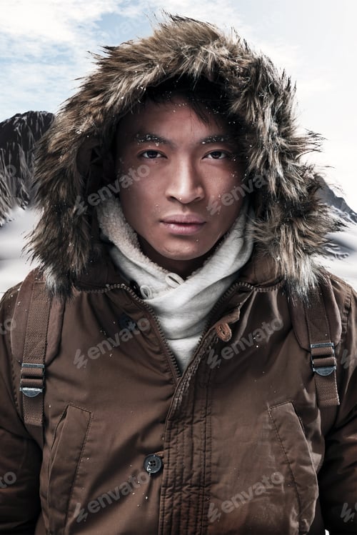 Preview: Asian Winter Sport Fashion Man With Backpack In Snow Mountain Landscape. Wearing Brown Jacket With