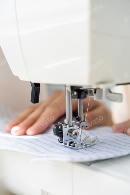 Preview: woman sews clothes on sewing machine. manufacture of dresses, shirts.