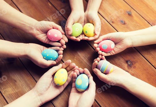 Preview: close up of woman hands with colored easter eggs