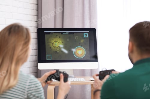 Preview: Young couple playing video game at home