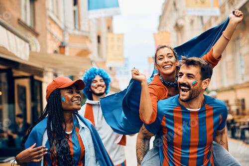 Preview: Cheerful sports fans having fun while celebrating on the street during the world championship.