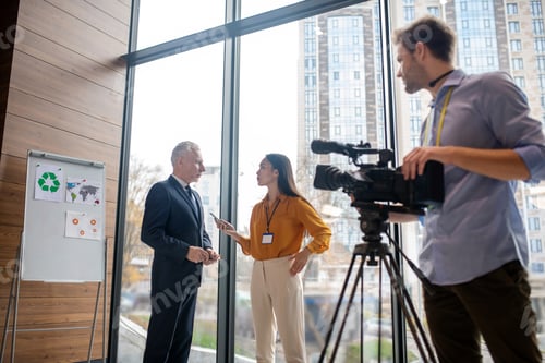 Preview: Male video operator looking at his colleague