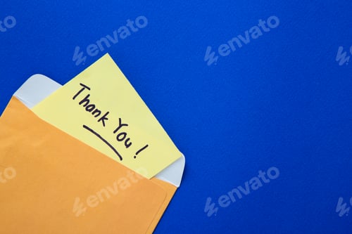 Preview: Thank you note on yellow paper in an envelope.