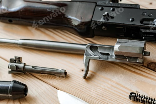 Preview: Shotgun parts on the wooden table background.