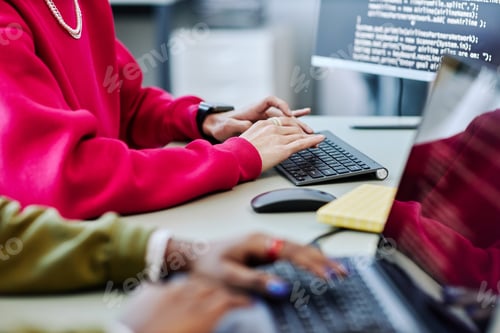 Preview: Close up of young person typing at computer keyboard writing code
