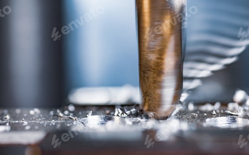 Preview: Drilling process with shavings close-up at the workplace in workshop