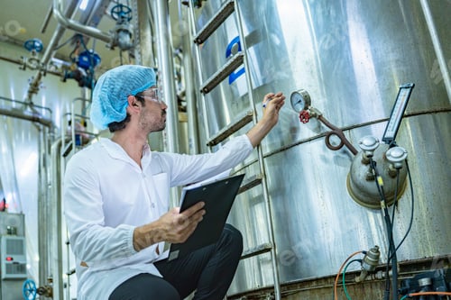 Preview: Professional conducting quality checks on a stainless steel tank
