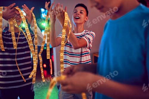 Preview: Teenage friends having fun with tickets in an amusement arcade