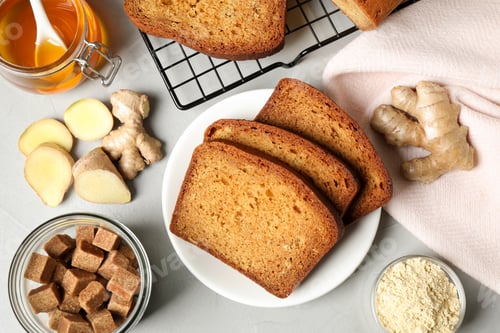 Preview: Fresh gingerbread cake slices and ingredients on light table, flat lay