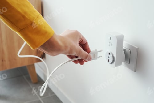 Preview: Woman plugging a device into a smart plug