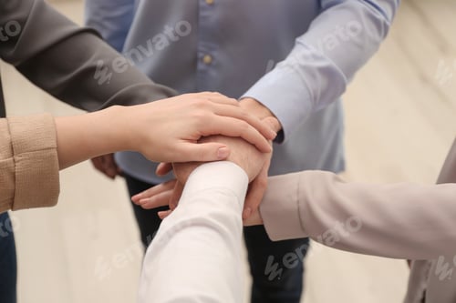 Preview: Group of people holding their hands together on blurred background, closeup