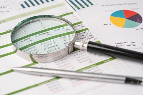 Preview: Magnifying glass on charts graphs paper. Financial development, Banking Account, Statistics.