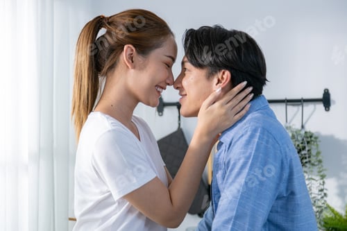 Preview: young couple happily makes breakfast and sweet treats together.
