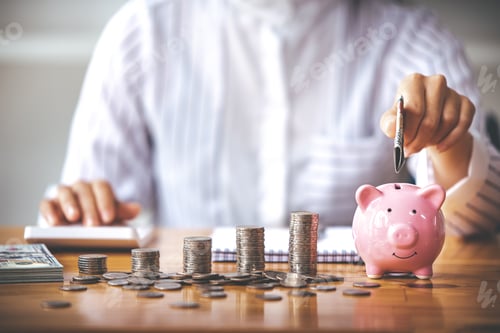 Preview: businessman holding a coin in a piggy bank On a table with sunlight. Money Saving Ideas for Financia
