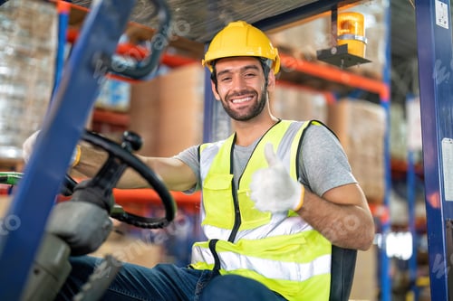 Preview: Forklift Truck Operator Lifts Pallet Cardboard Boxes On a Shelf by Trucks in Distribution Center