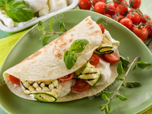Preview: piadina with mozzarella, grelled zucchinis and tomatoes, typical italian sandwich