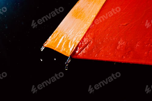 Preview: Detail of an umbrella with raindrops after a rainy day.