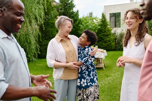 Preview: Happy cute boy in stylish shirt giving hug to his grandmother and looking at her