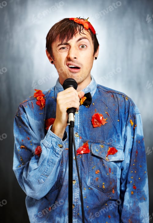 Preview: Seriously unfunny. Portrait of an unsuccessful standup comedian covered in rotten tomatoes.