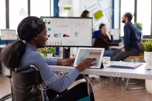 Preview: Handicapped african american businesswoman in wheelchair analyzing financial graph