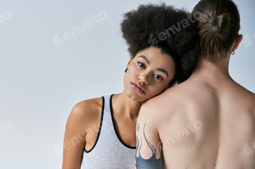 Preview: beautiful african american woman in underwear lovingly putting her head on shoulder of her boyfriend