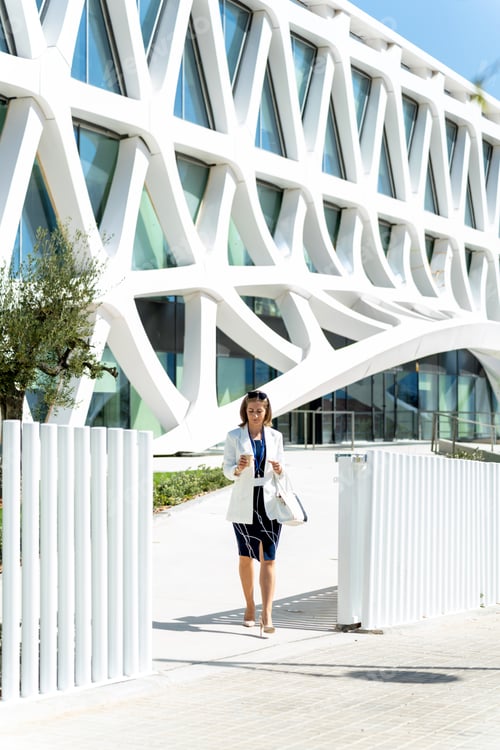 Preview: Executive German business woman dressed in suit leaving the office