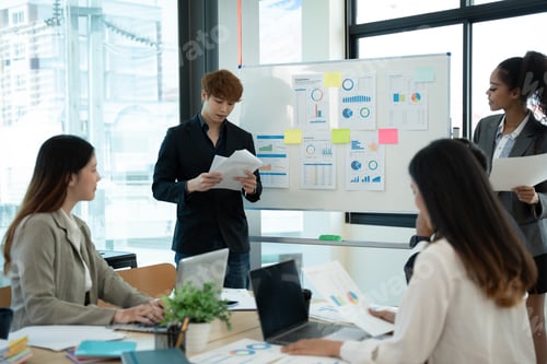 Preview: Business people discussing documents and ideas at meeting