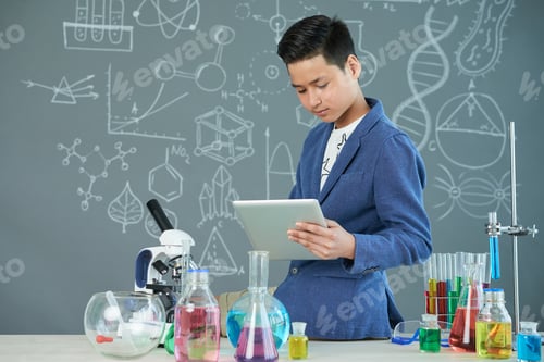 Preview: Asian Student Working on Laboratory Report