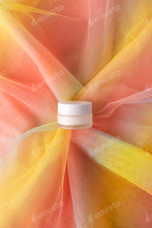 Preview: White jar for beauty product on colorful rainbow organza fabric