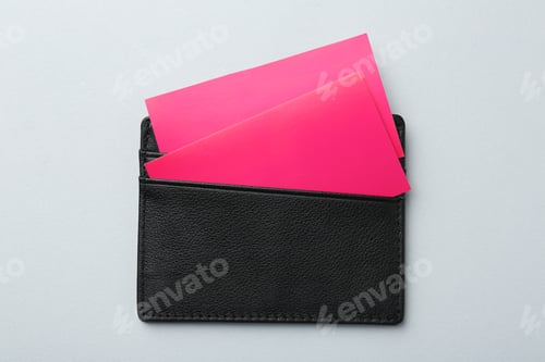 Preview: Leather business card holder with colorful cards on light grey background, top view