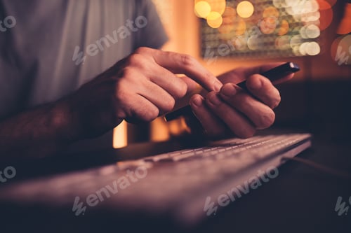 Preview: Bored man wasting time using mobile phone