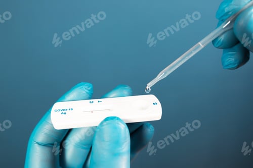 Preview: Doctor with laboratory COVID-19 test kit for diagnosis coronavirus infection.