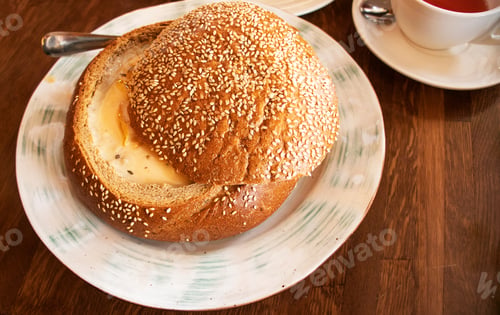 Preview: cream soup in a plate of bread in a cafe