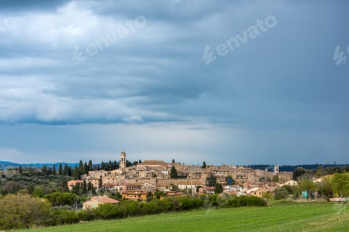 Preview: Horizontal shot of a lot of buildings surrounded by green trees under the beautiful cloudy sky