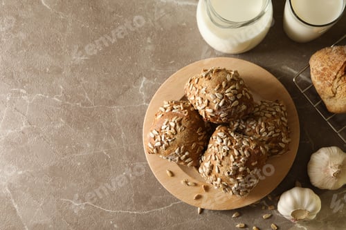 Preview: Fresh baked buns and milk on gray table