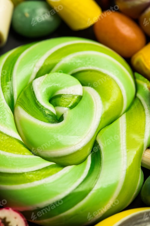 Preview: close up view of swirl green tasty shiny sweet lollipop