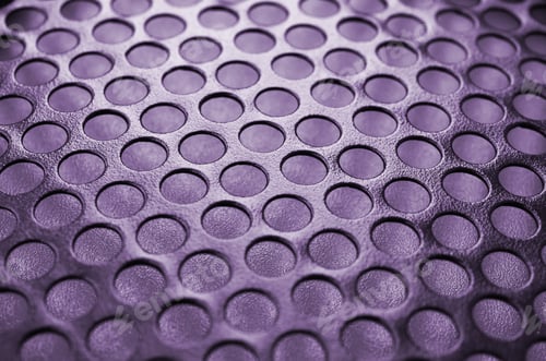 Preview: Black metal computer case panel mesh with holes on purple background. Abstract close up
