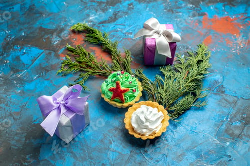 Preview: bottom view small tarts small gifts pine branches on blue red background